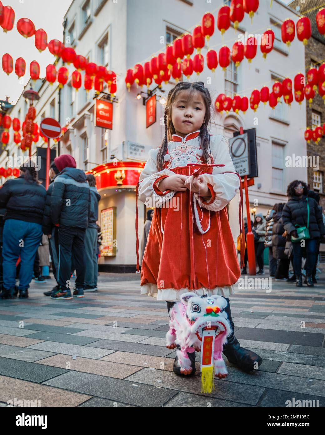 A chinese girl with her dragon in London's Chinatown during the celebration of the lunar new year. Stock Photo