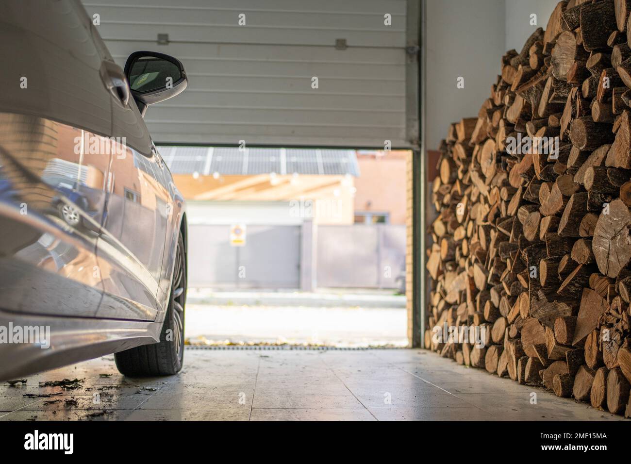 Low angle view of garage with a parked car full of firewood for the winter Stock Photo Alamy