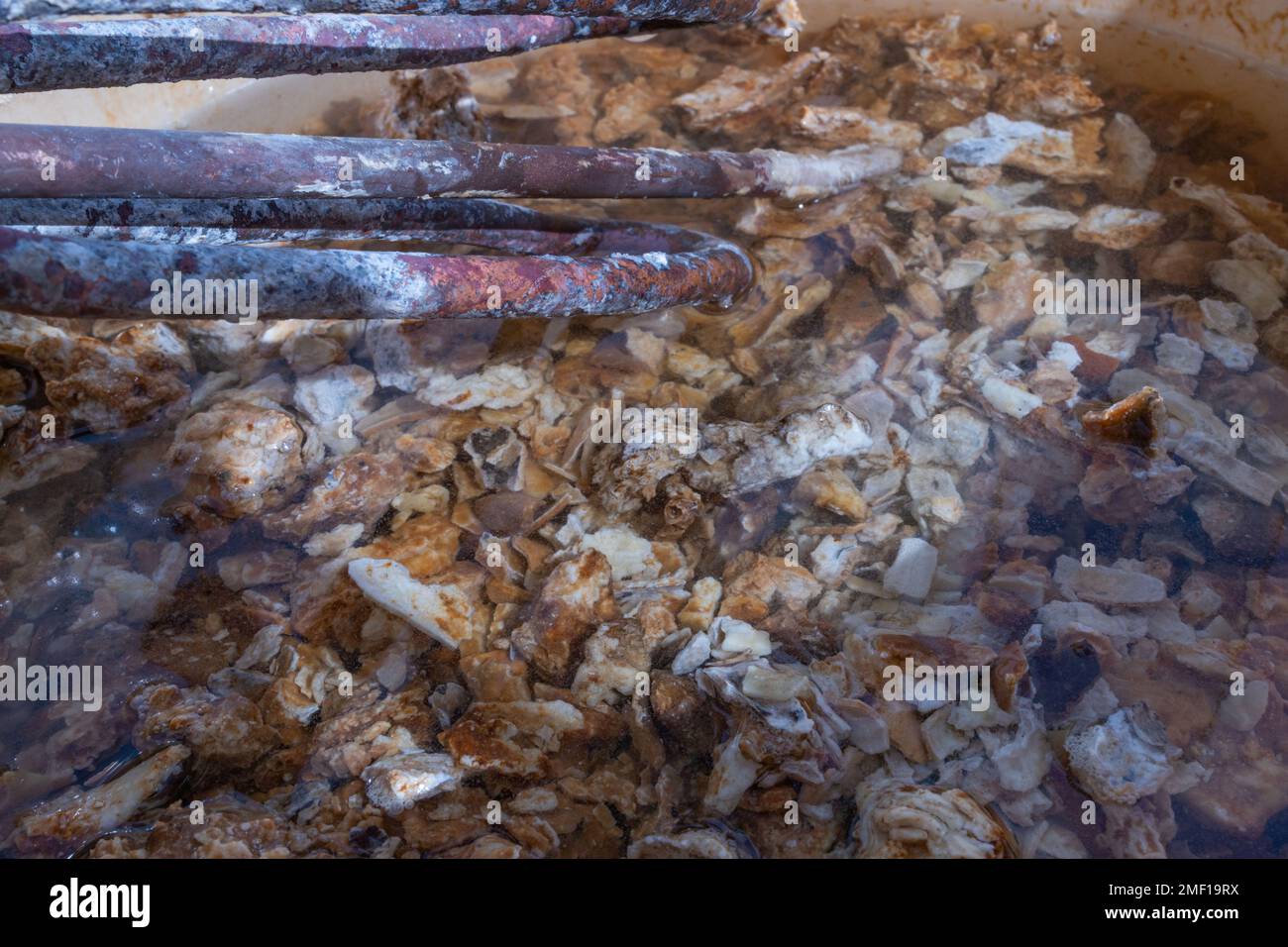 boiler cleaning. rusty heater, coated with scale. heater surrounded by