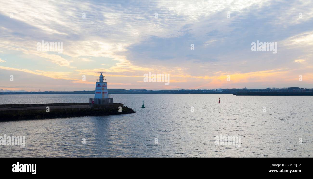 Sunset casting a reflection across the water by the pier  at Hartlepool Headland,England,UK Stock Photo
