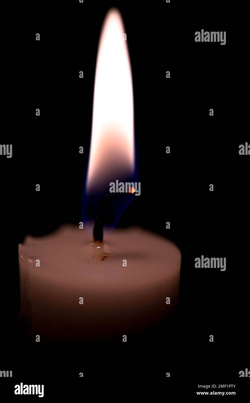 one burning candle in dark black room Stock Photo - Alamy