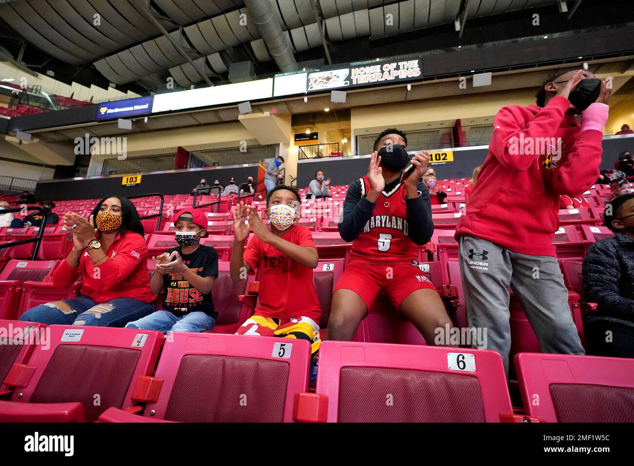 Tierra Haynes, left, wife of Maryland assistant coach DeAndre Haynes, not  visible, cheers while sitting with their children, from left, Dallas  Haynes, 6, Devon Haynes, 8, DeAndre Haynes Jr., 13, and the