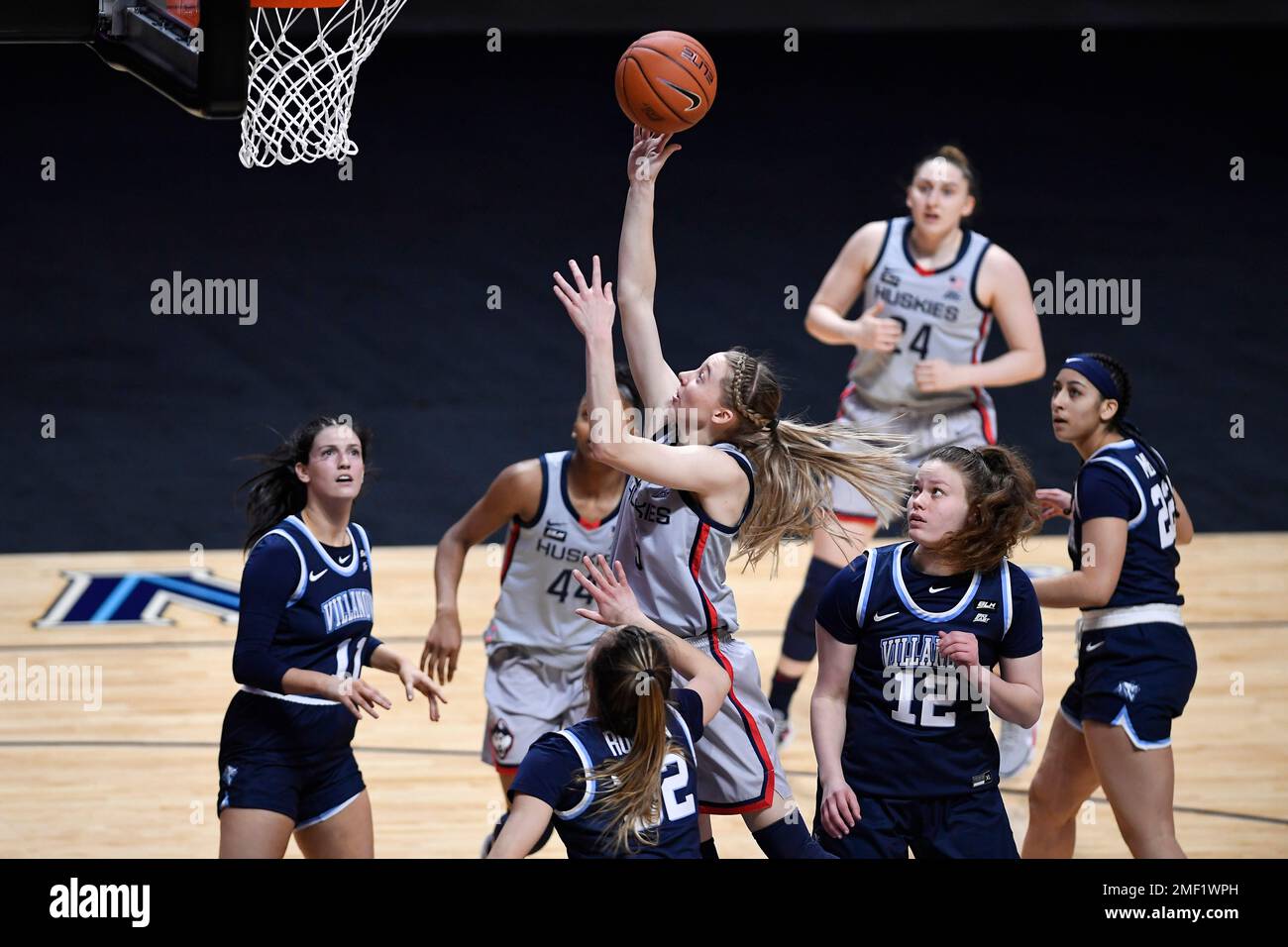 Connecticut's Paige Bueckers, center, shoots as Villanova's Bella