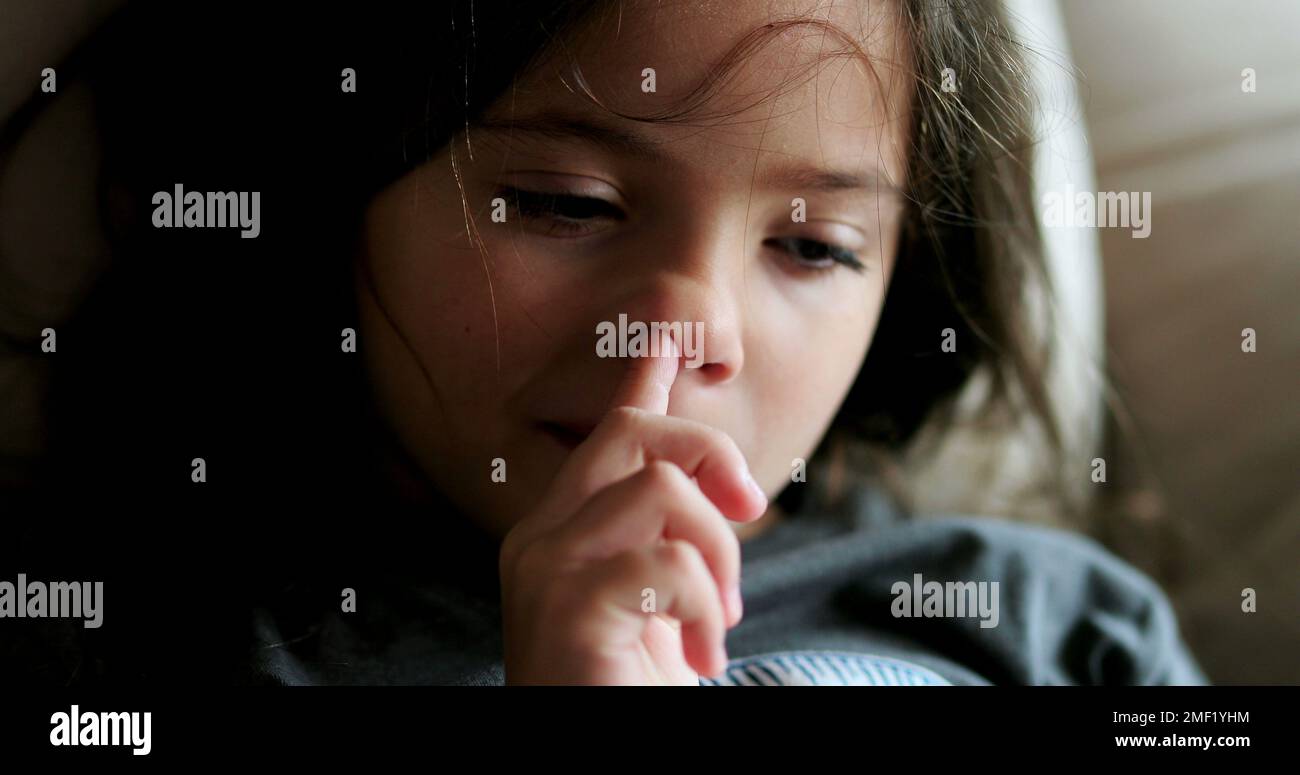 Little girl scratching nose with hand child rubbing face Stock Photo Alamy