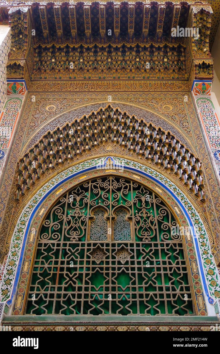 Fez, Morocco - outer south wall of Fes founder tomb in Zaouia Moulay Idriss II. Zawiya mausoleum facade with carved stucco, painted wood, and zellij. Stock Photo