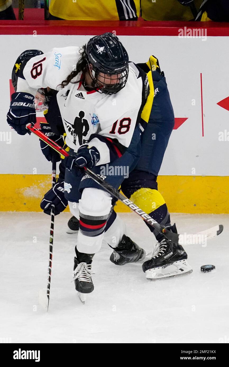 Women's Sports Foundation New Hampshire's Lillian Ribeirinha-Braga (18)  battles for the puck against Team Adidas Minnesota's Nicole Schammel during  the third period of the Dream Gap Tour women's hockey game at the