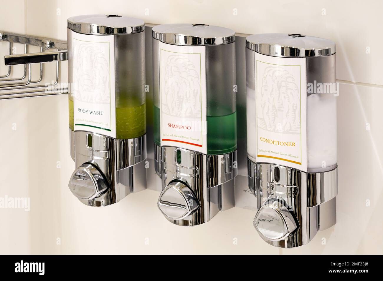 Luxury body wash liquid soap, shampoo and conditioner dispensers boxes on hotel bathroom shower