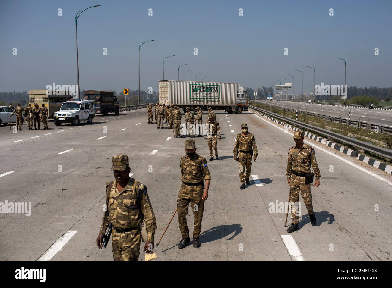 Indian paramilitary soldiers stand guard at a check point on a