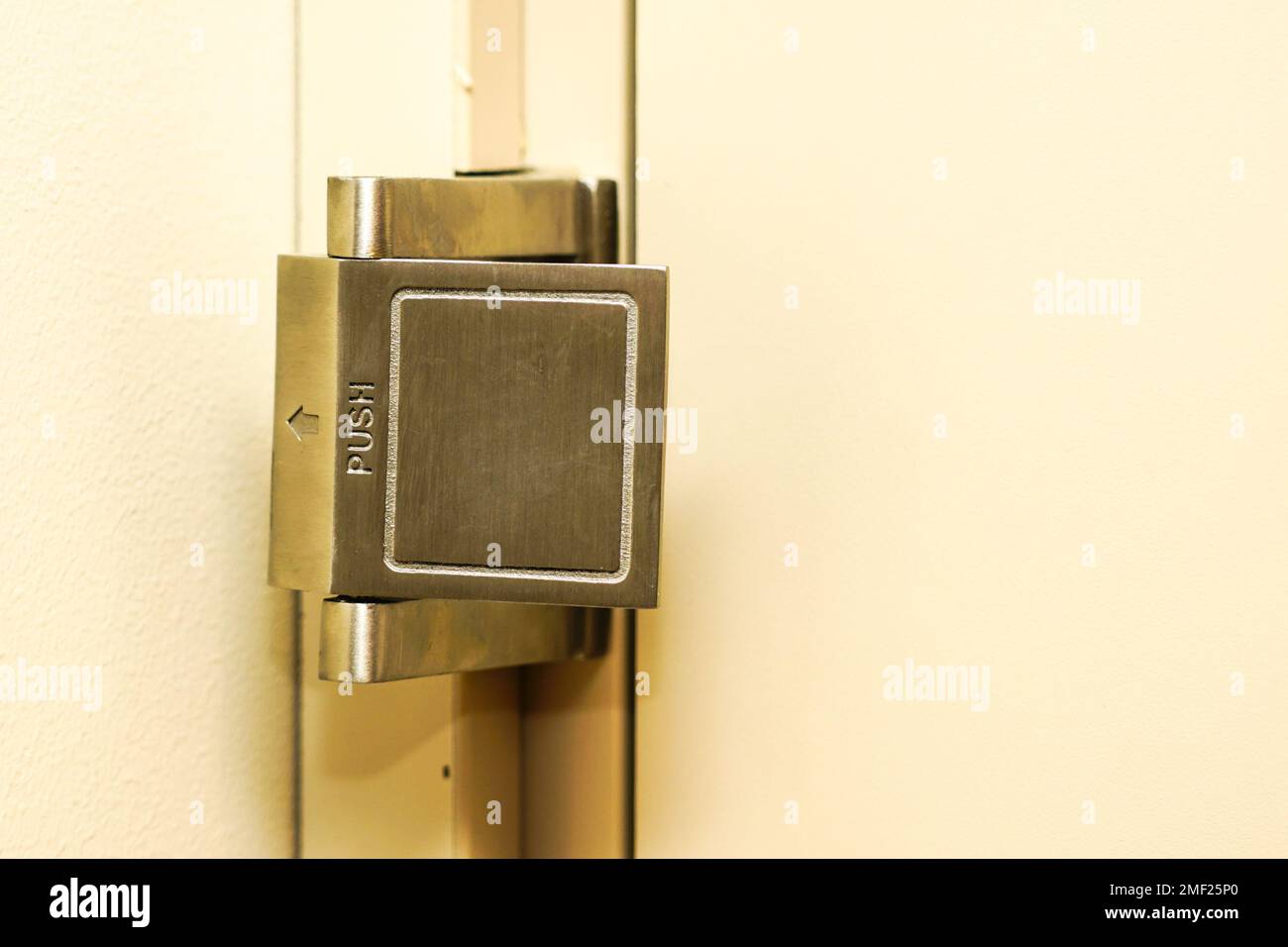 A mechanical door blocker on the inside of a hotel room door, blocking device for door opening