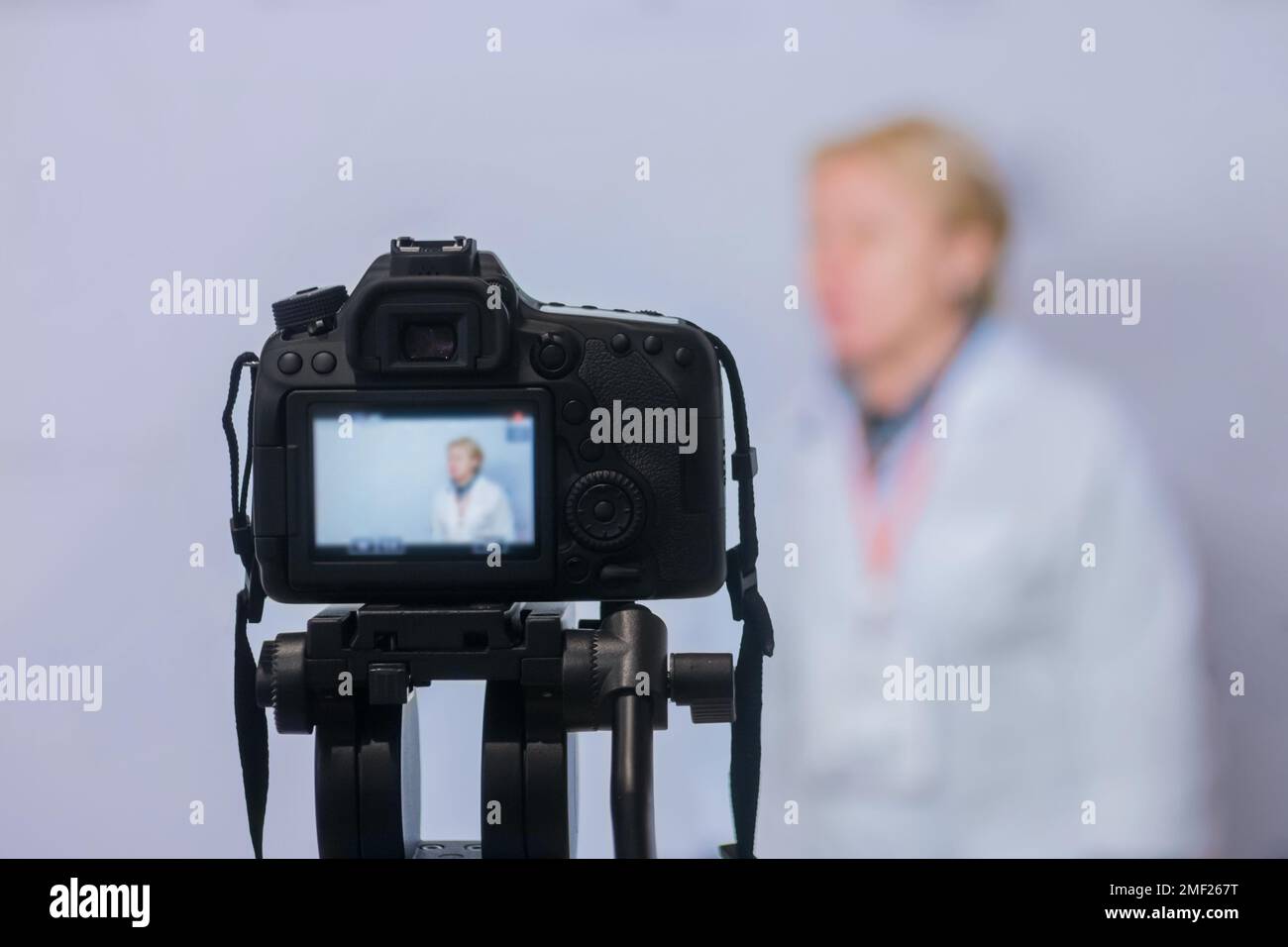 Dslr camera recording interview in broadcast news studio Stock Photo