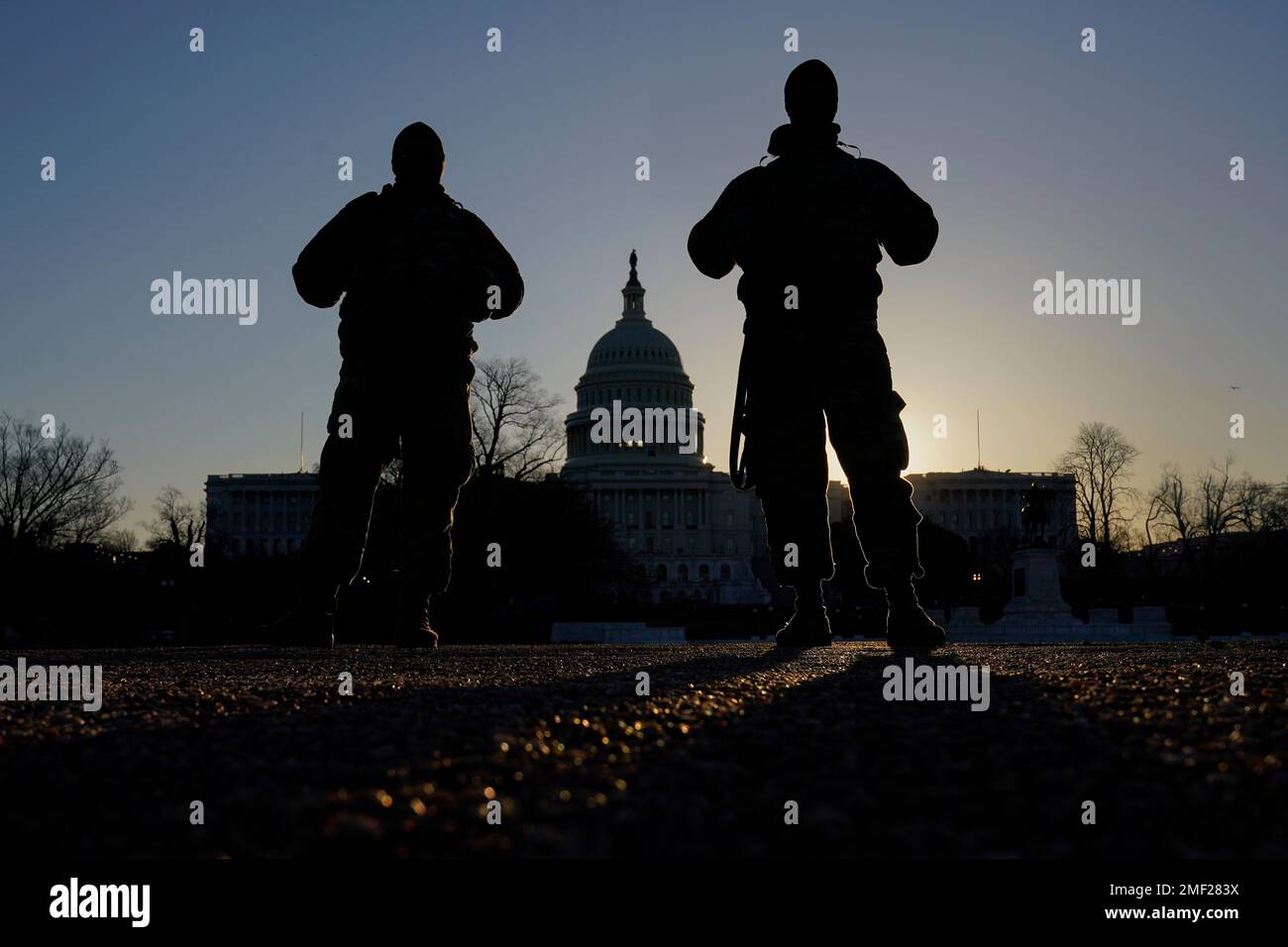 National Guard stand their post at sunrise at the Capitol in Washington ...