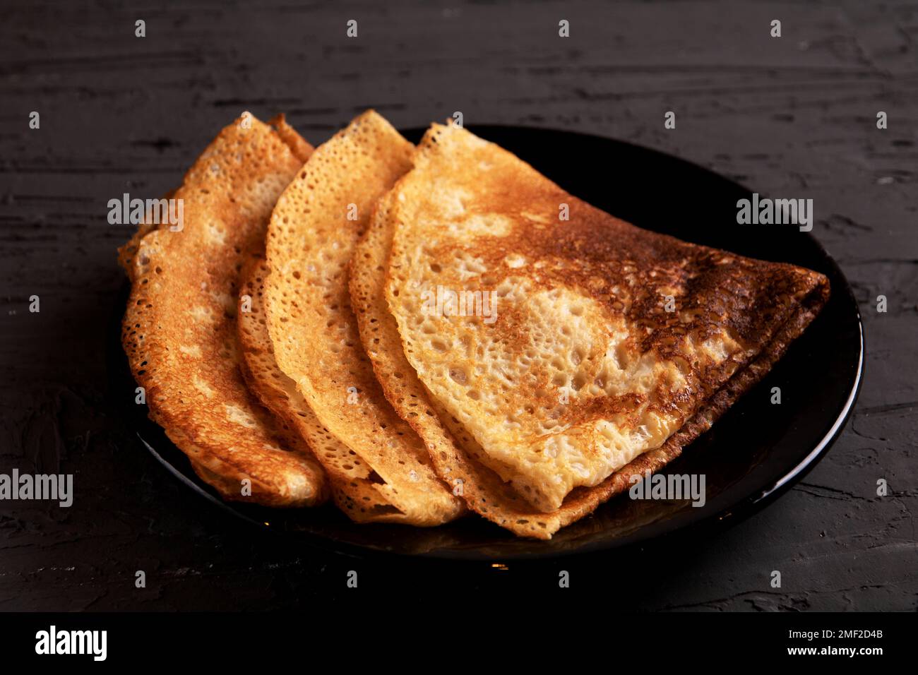 photo three fried pancakes lying on a plate Stock Photo