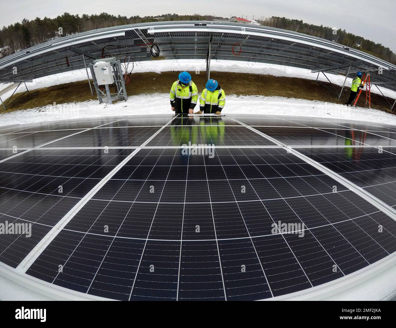 Electricians Bryan Driscoll and Zach Newton and consult a wiring