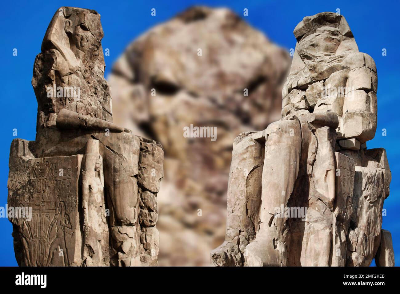 In the city of Luxor there are two huge twin statues, the Colossi of Memnon representing Pharaoh Amenhotep III and are placed in front of his funerary Stock Photo