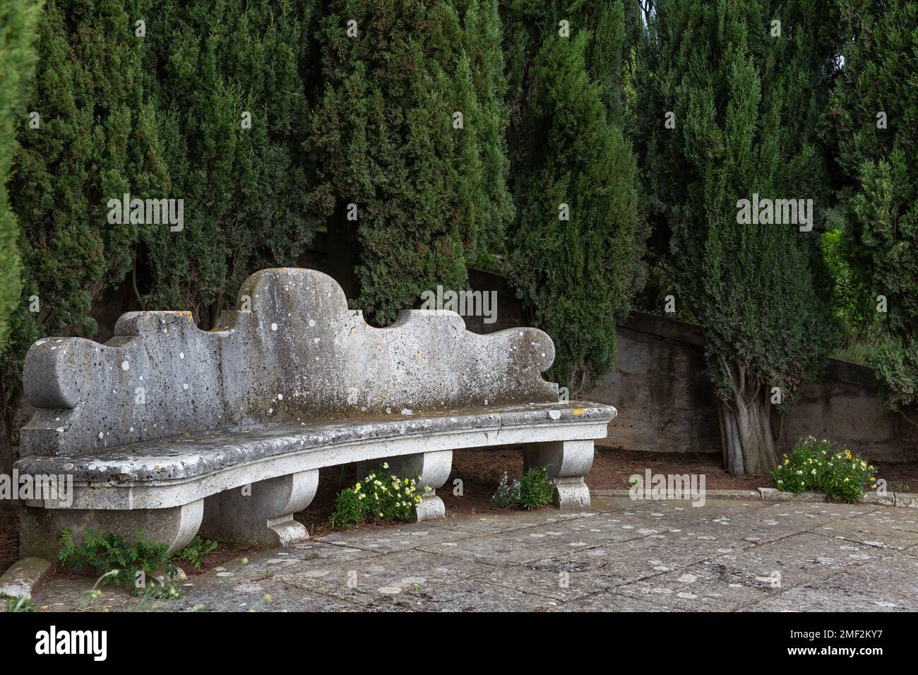 Stone bench in the Garden of La Foce, one of Italy's most beautiful private gardens, in the Tuscan region of Val d'Orcia. Stock Photo