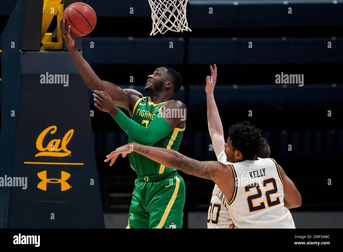 Oregon forward Eugene Omoruyi, left, shoots against California forward Andre Kelly (22) and