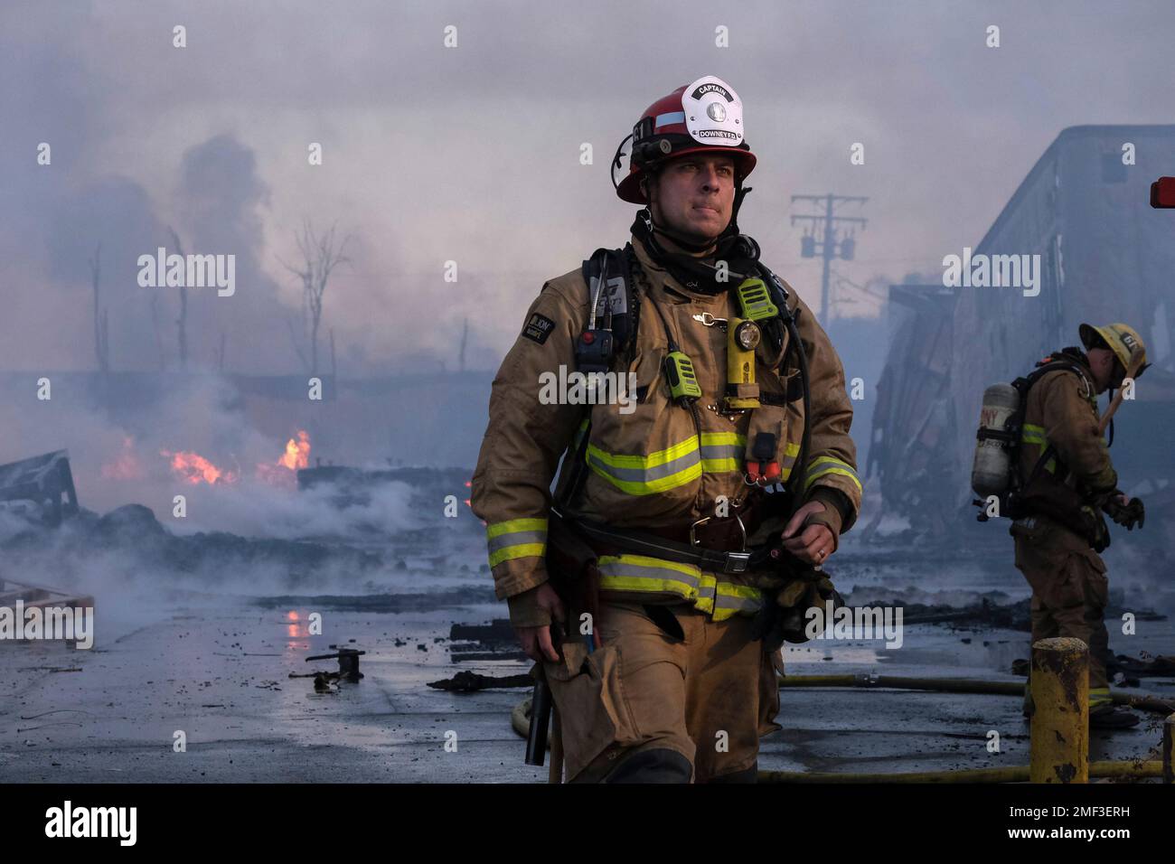 Firefighters battle a fire at a commercial yard in Compton, Calif., on ...