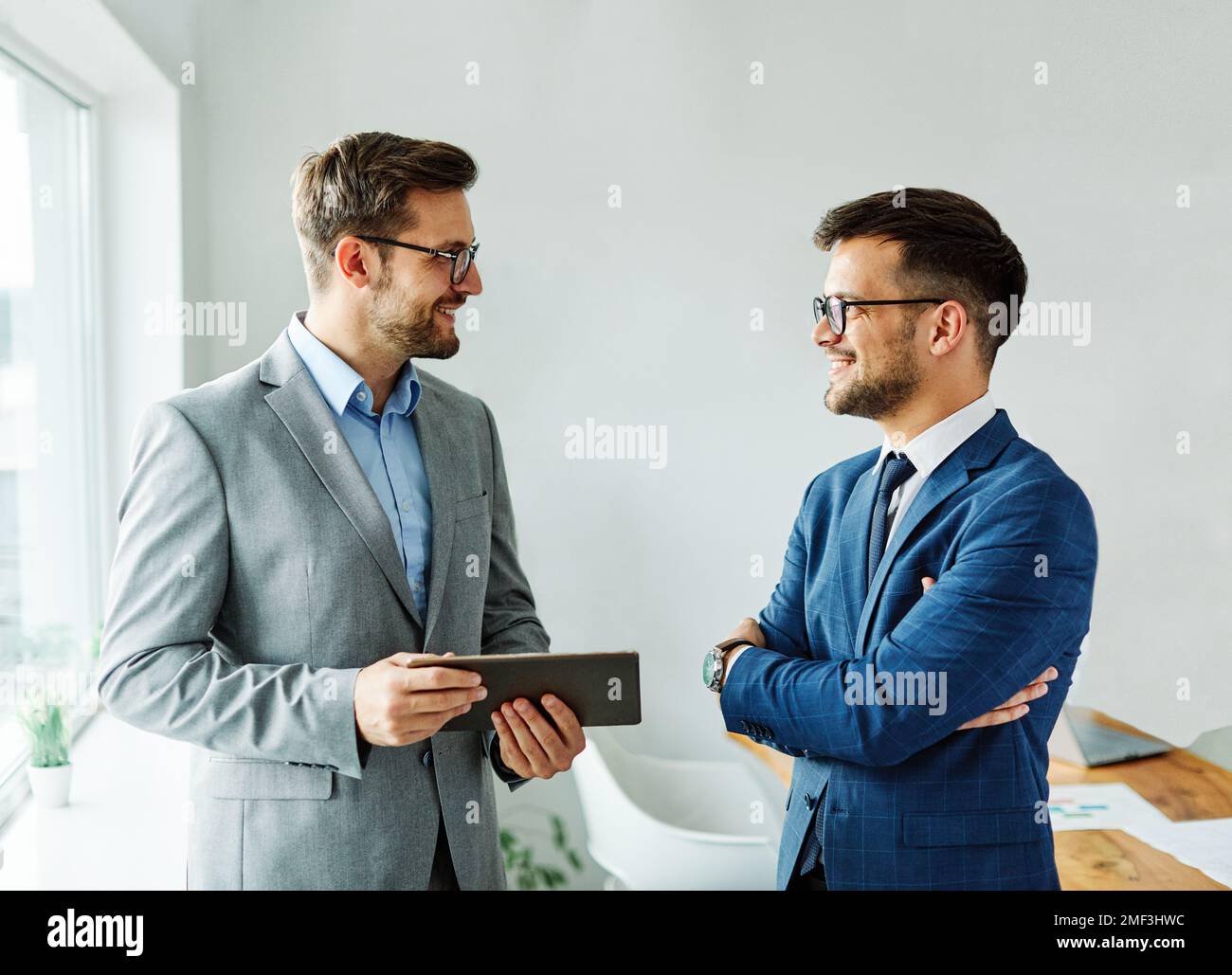 young business people businesspeople businessman meeting office teamwork success corporate discussion tablet computer Stock Photo