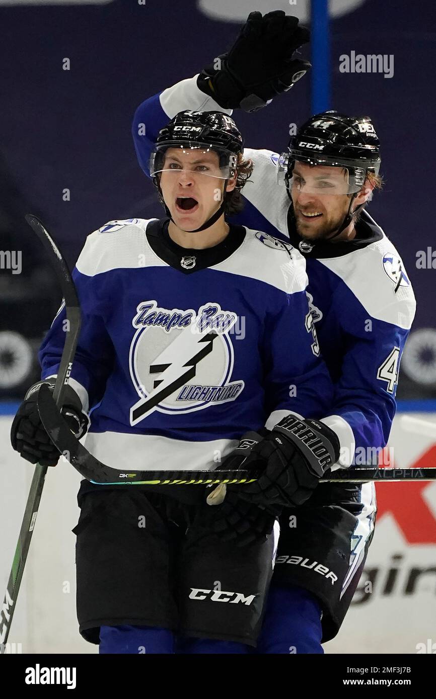 Tampa Bay Lightning center Yanni Gourde (37) celebrates his goal against the Carolina Hurricanes with defenseman Jan Rutta (44) during the third period of an NHL hockey game Thursday, Feb