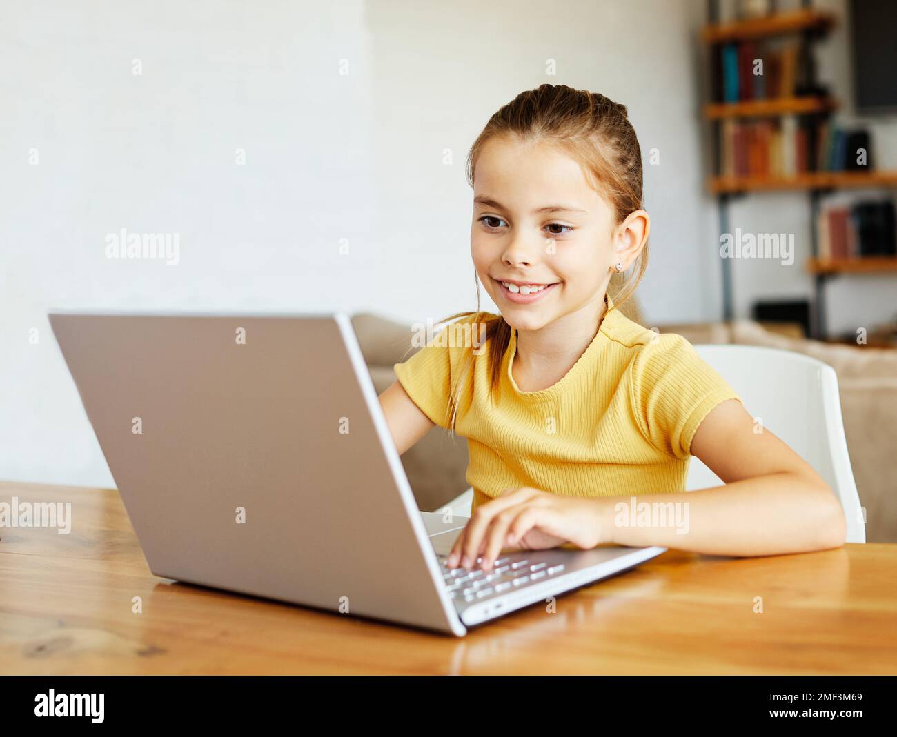 child laptop computer technology home girl education homework kid learning internet childhood student sitting connection using online Stock Photo