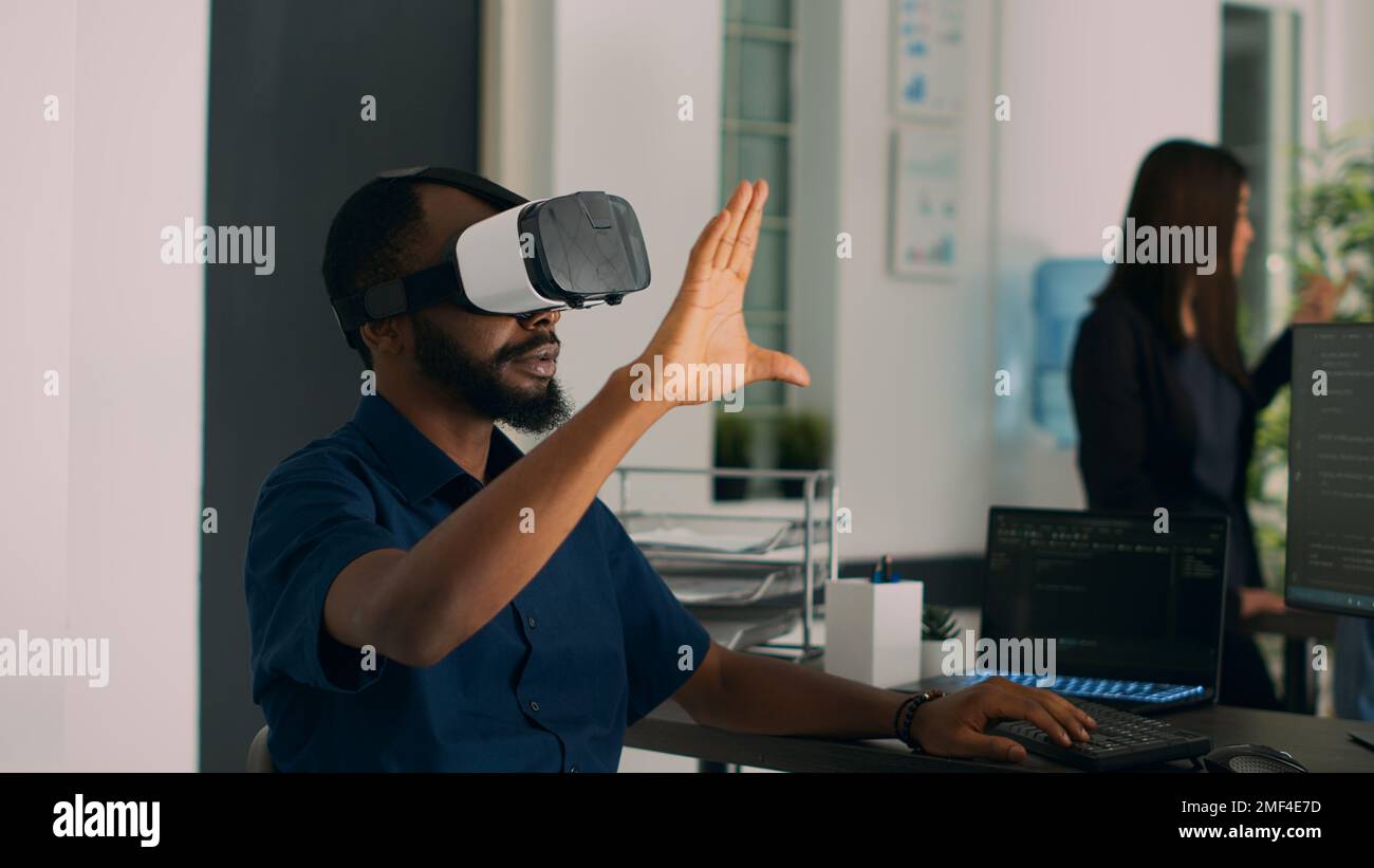 Database admin working with virtual reality glasses to develop server app in it agency office, using source code. Checking programming language on cloud computing database, web developer. Stock Photo