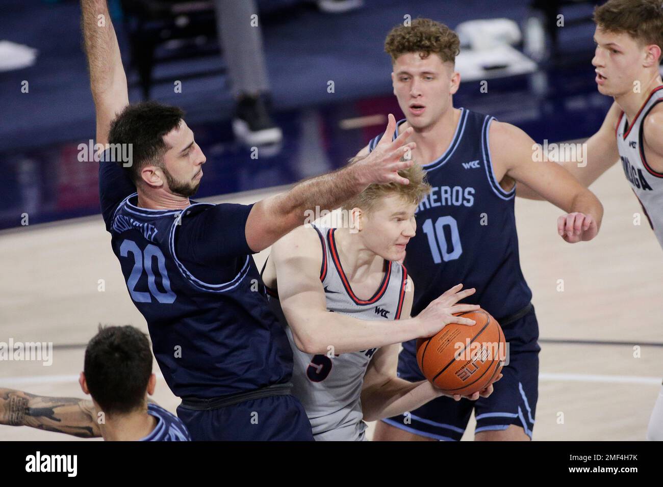Gonzaga guard Martynas Arlauskas (5) looks to pass between San Diego  forward Jared Rodriguez (20) and forward Mikal Gjerde (10) during the  second half of an NCAA college basketball game in Spokane,