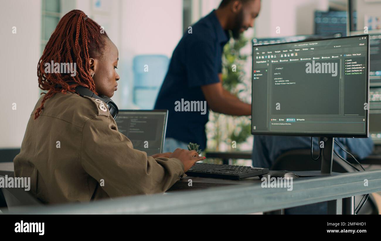 Software developer typing programming code on computer to develop online cloud computing information. Web programer writing html script and data algorithm on computer. Handheld shot. Stock Photo