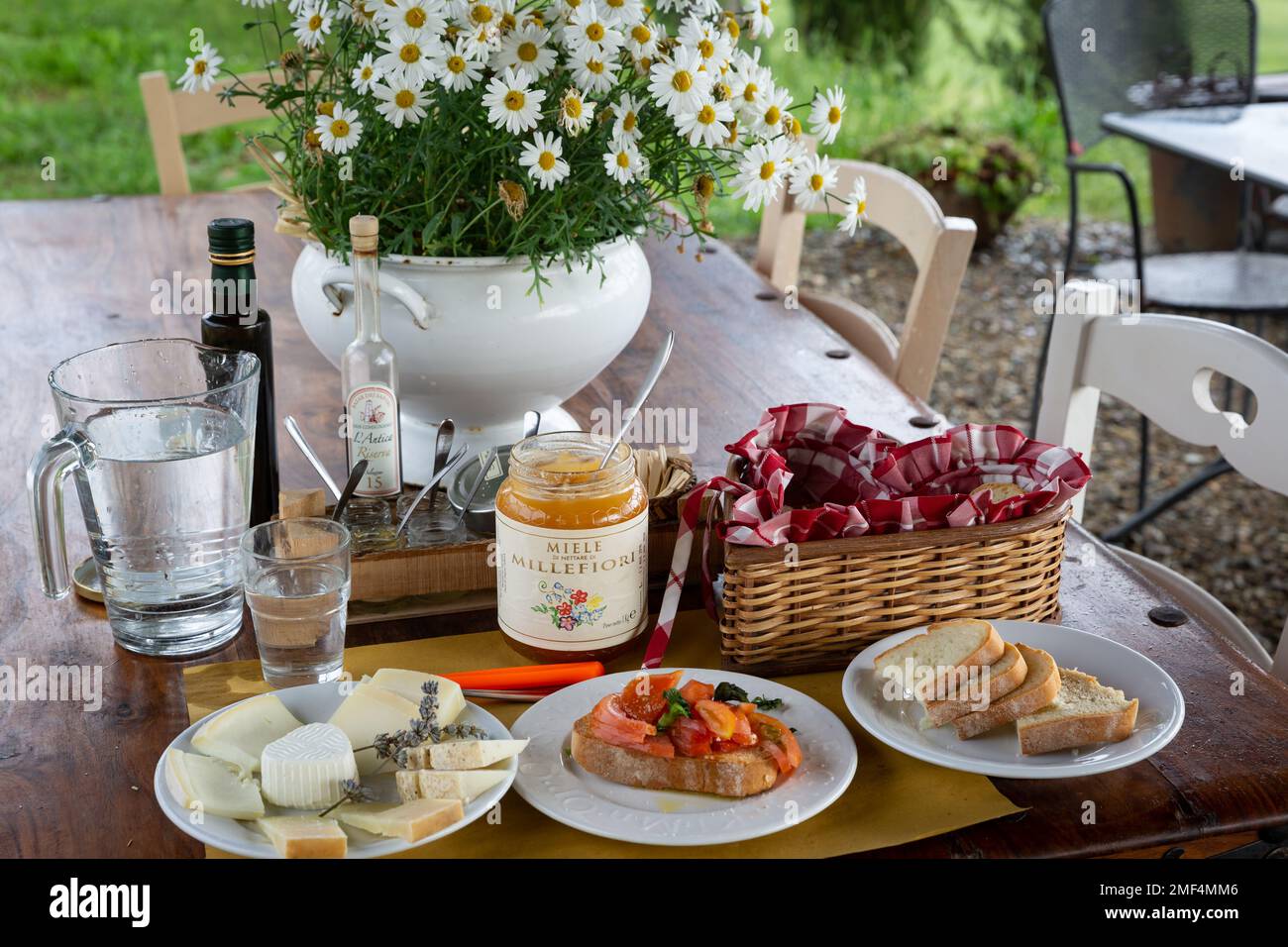 Taste testing a variety of goat and pecorino cheeses, paired with honey, at cheese farm in Tuscany, Italy. Stock Photo