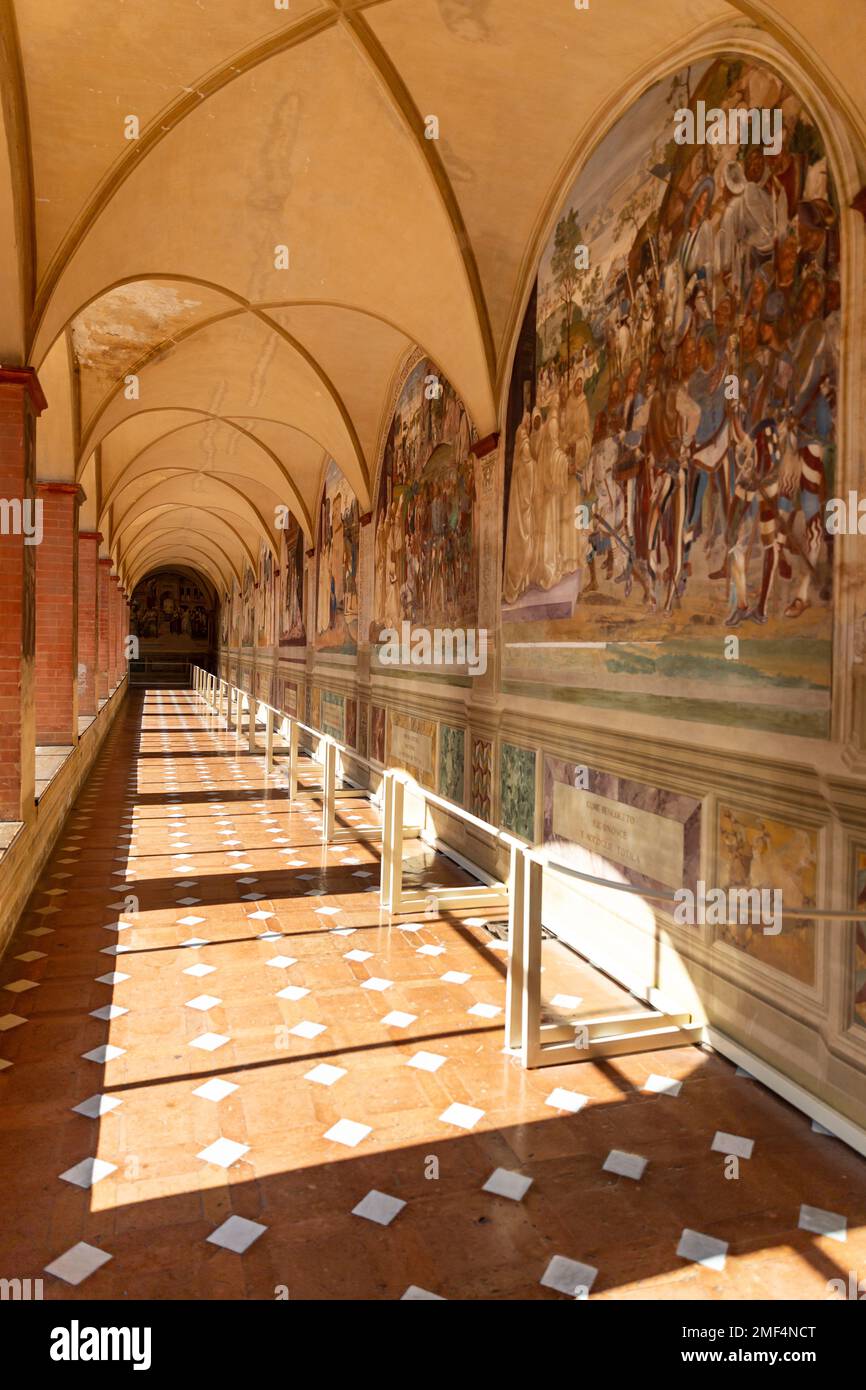 Arched hallway of the Abbey of Monte Oliveto Maggiore, a Benedictine monastery near Asciano in Tuscany, province of Siena, Italy. Stock Photo