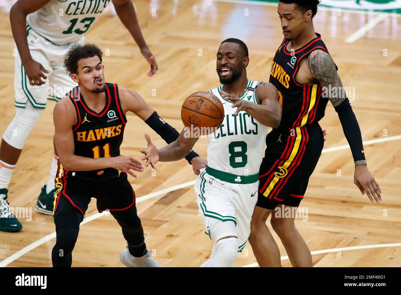 Atlanta Hawks' John Collins, right, fouls Boston Celtics' Kemba Walker