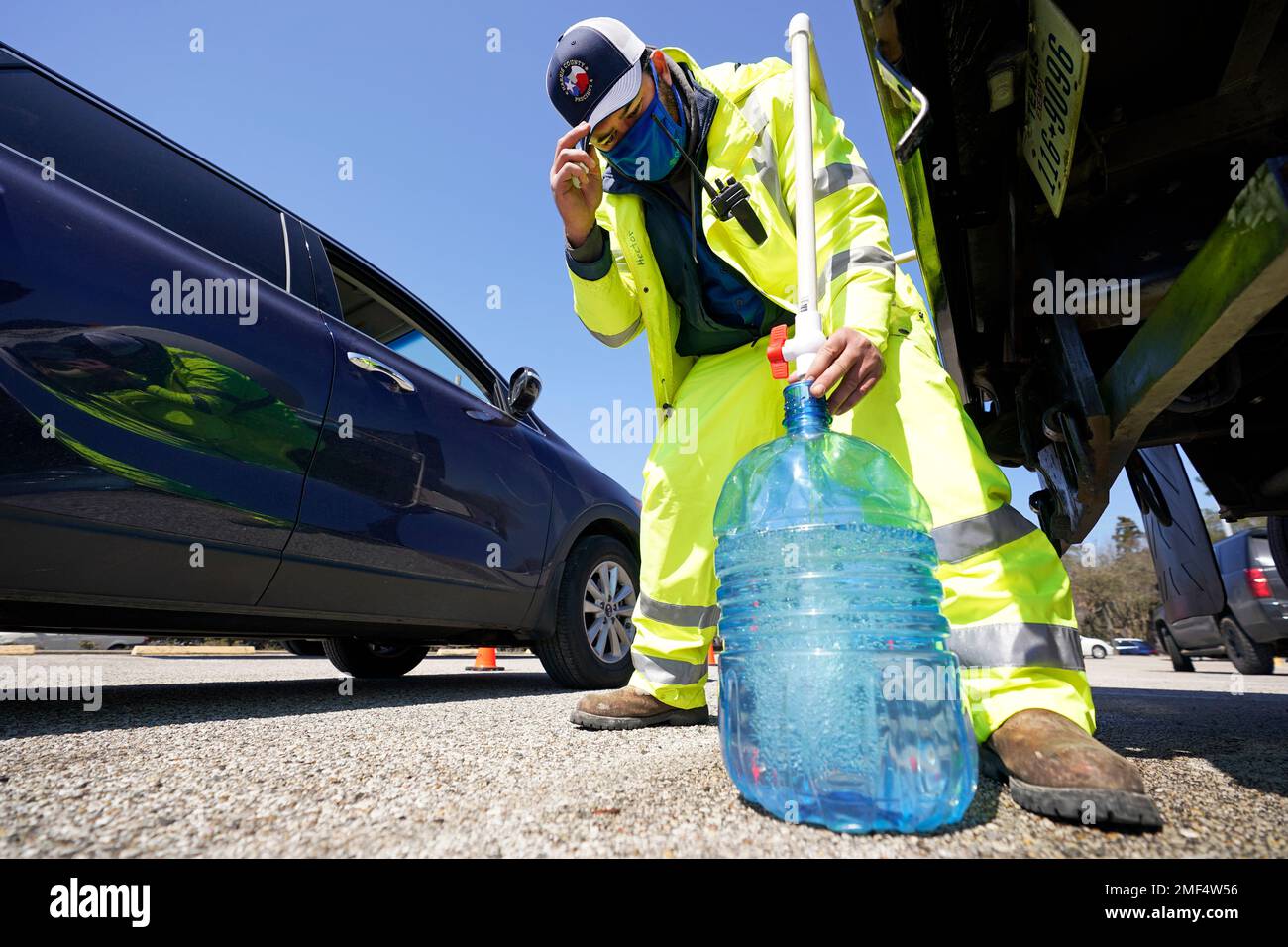 Harris County Precinct 4 employee Hector Plascencia fills containers