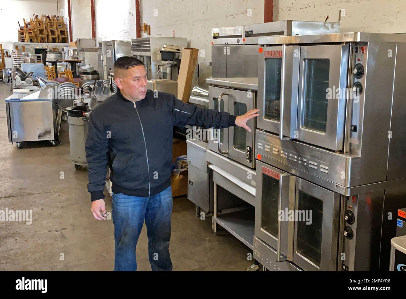 Jose Bonilla Jr. shows a used industrial oven for sale in the