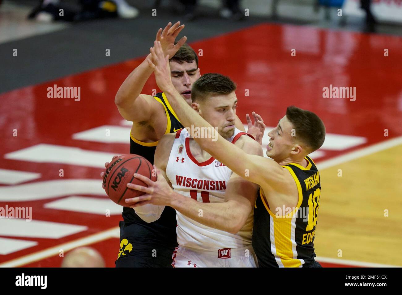 Iowa's Luka Garza, left, and Iowa's Joe Wieskamp (10) surround