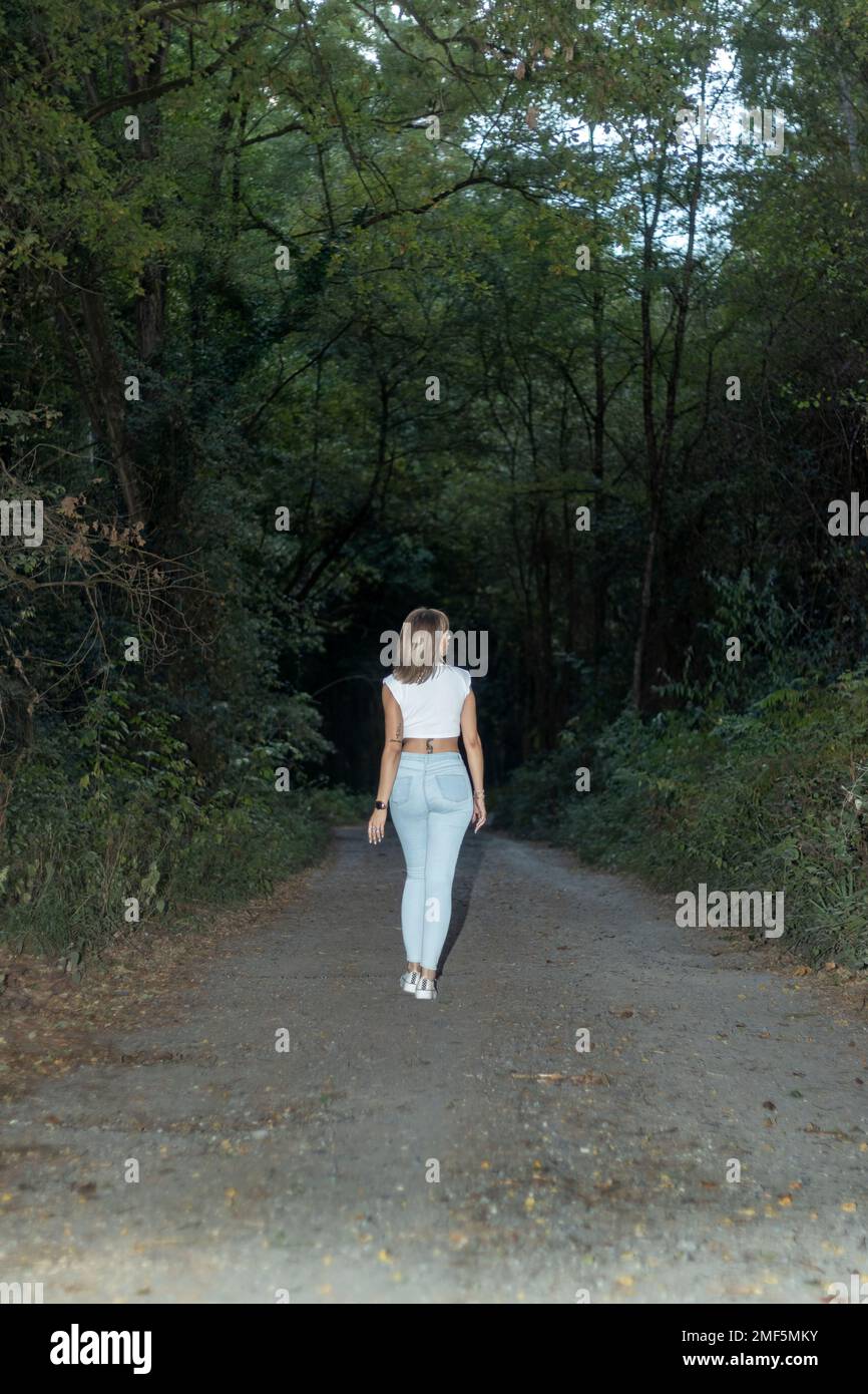 Woman walking on an empty road hi-res stock photography and images - Alamy