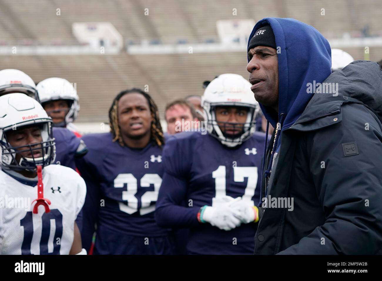 Jackson State football coach Deion Sanders speaks with players