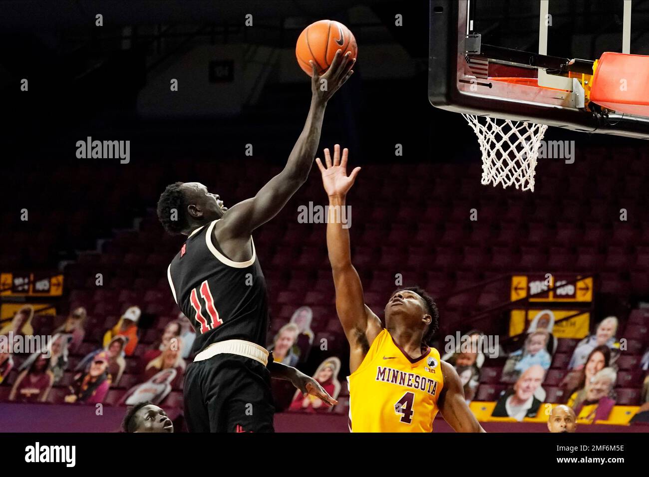 Nebraska's Lat Mayen (11) lays up a shot over Minnesota's Jamal