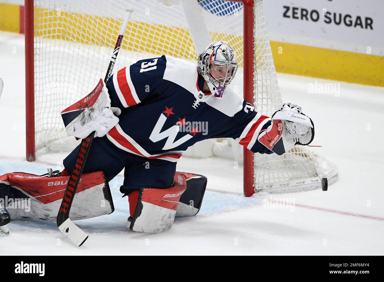 Washington Capitals goaltender Craig Anderson (31) reaches for the puck ...