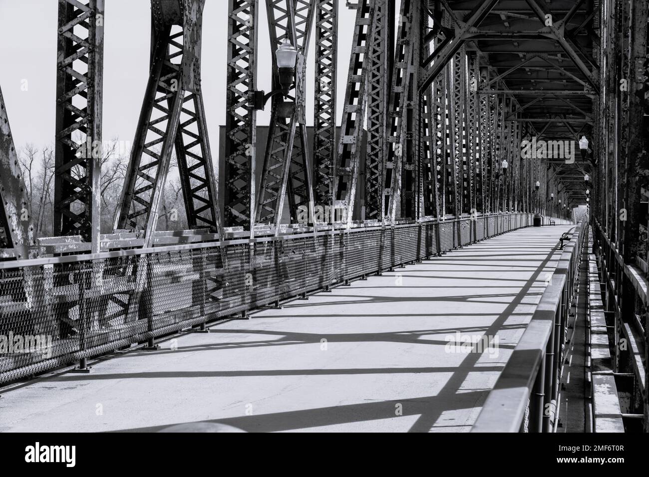 A grayscale of the Meridian Bridge under the sunlight in Yankton, South Dakota Stock Photo