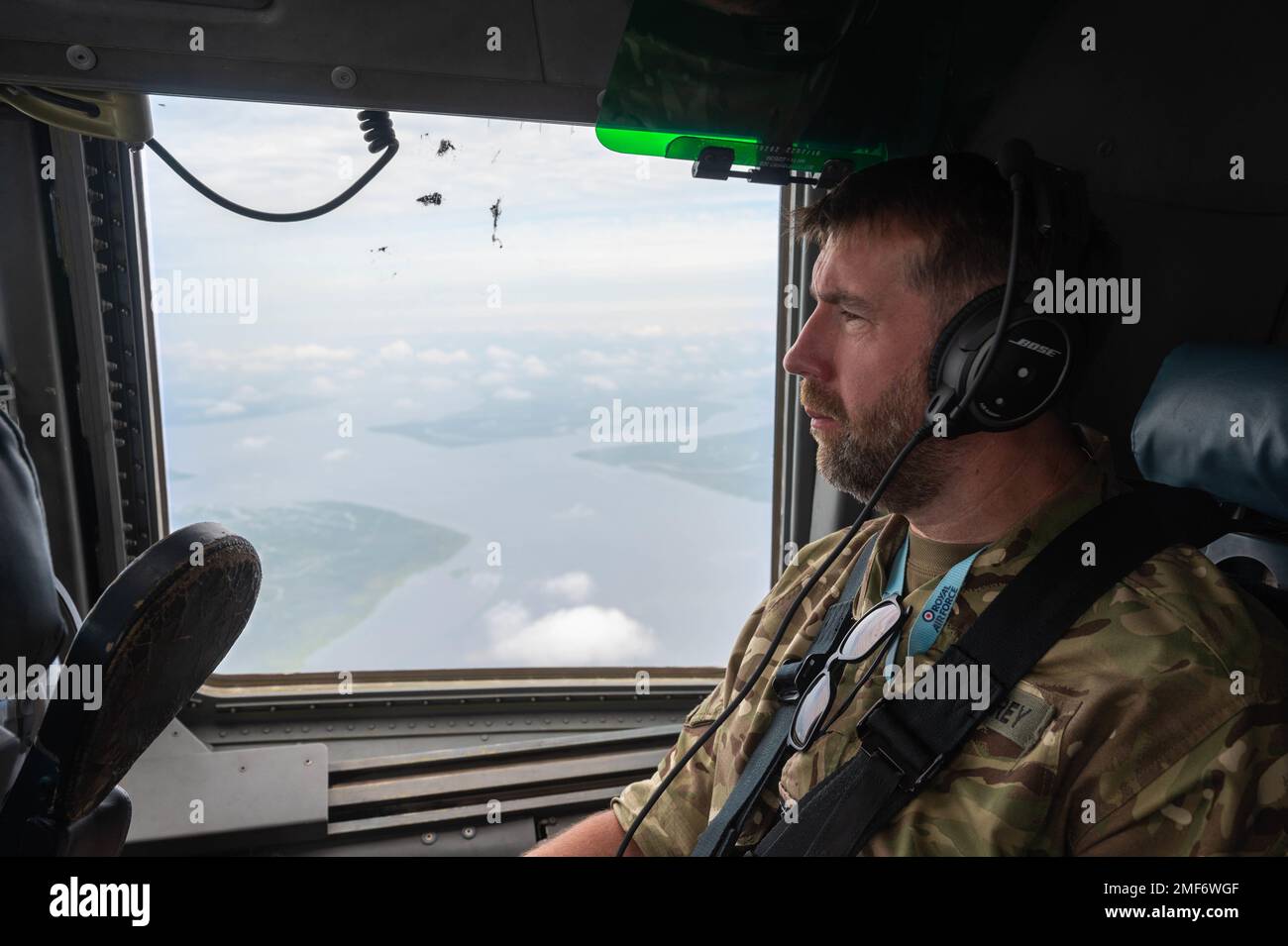Flight Lieutenant Ronan Carey, Royal Air Force head of digital and social media communications, rides in a C-17 Globemaster III assigned to the 317th Airlift Squadron, Joint Base Charleston, South Carolina, while participating in the Military Reserve Exchange Program (MREP), August 17, 2022. MREP provides National Guard and Reserve members the opportunity to serve with NATO alliance partners in a duty assignment similar to their wartime assignment while gaining the understanding of the training, doctrine, and operations of foreign allies. Stock Photo
