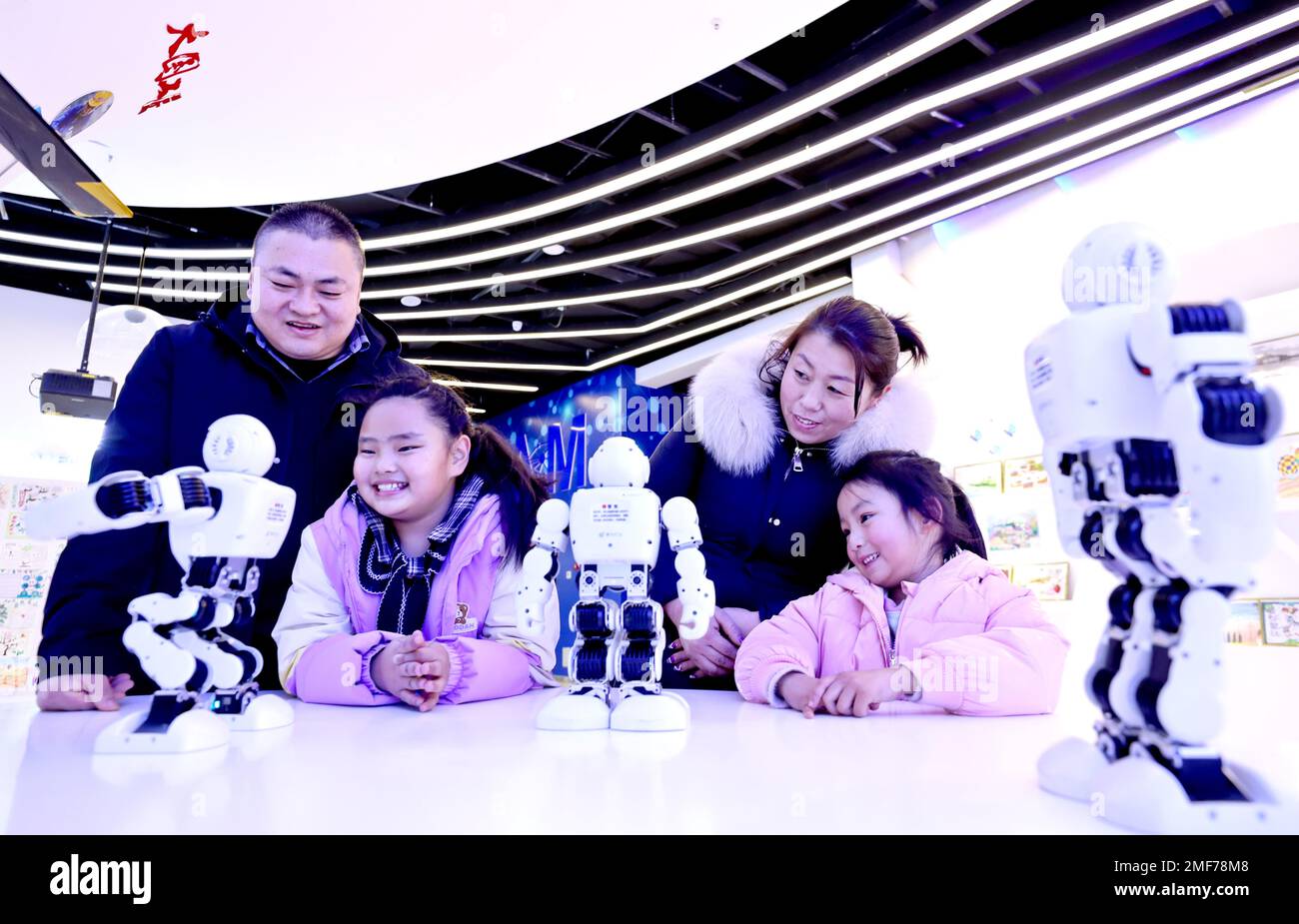 ZHANGYE, CHINA - JANUARY 24, 2023 - Parents and children watch a robot dance at Zhangye Science and Technology Museum in Linze county of Zhangye city, Stock Photo