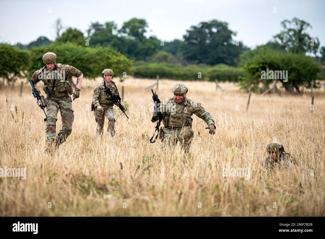 Airmen from the 423d Security Forces Squadron advance their position during a field training exercise at Stanford Training Area, England, Aug. 17, 2022. Instructors from the 820th Base Defense Group and 435th Security Forces Squadron Ground Combat Readiness Training Center, conducted the exercise to evaluate and bolster the combat readiness skills of the defenders from the 423d SFS. Stock Photo