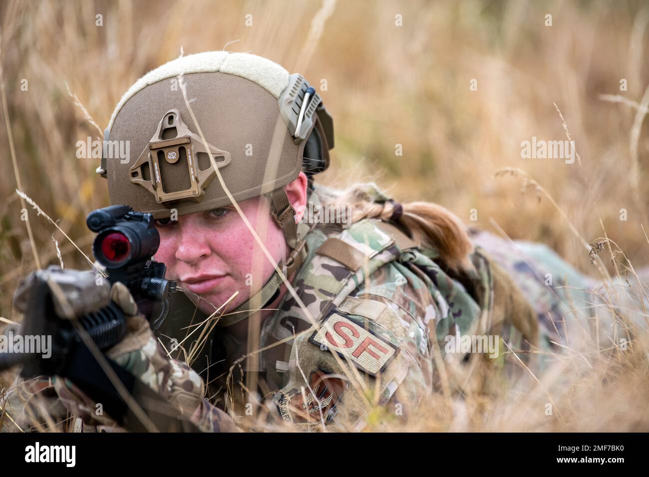 U.S. Air Force Airman 1st Class Sierra Capobianco, 423d Security Forces Squadron base defense operations center controller, looks down the sight of an M4 carbine during a field training exercise at Stanford Training Area, England, Aug. 17, 2022. Instructors from the 820th Base Defense Group and 435th Security Forces Squadron Ground Combat Readiness Training Center, conducted the exercise to evaluate and bolster the combat readiness skills of the defenders from the 423d SFS. Stock Photo