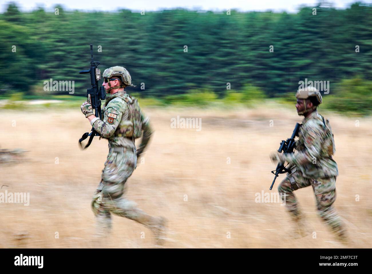 Airmen from the 423d Security Forces Squadron advance their position during a field training exercise at Stanford Training Area, England, Aug. 17, 2022. Instructors from the 820th Base Defense Group and 435th Security Forces Squadron Ground Combat Readiness Training Center, conducted the exercise to evaluate and bolster the combat readiness skills of the defenders from the 423d SFS. Stock Photo