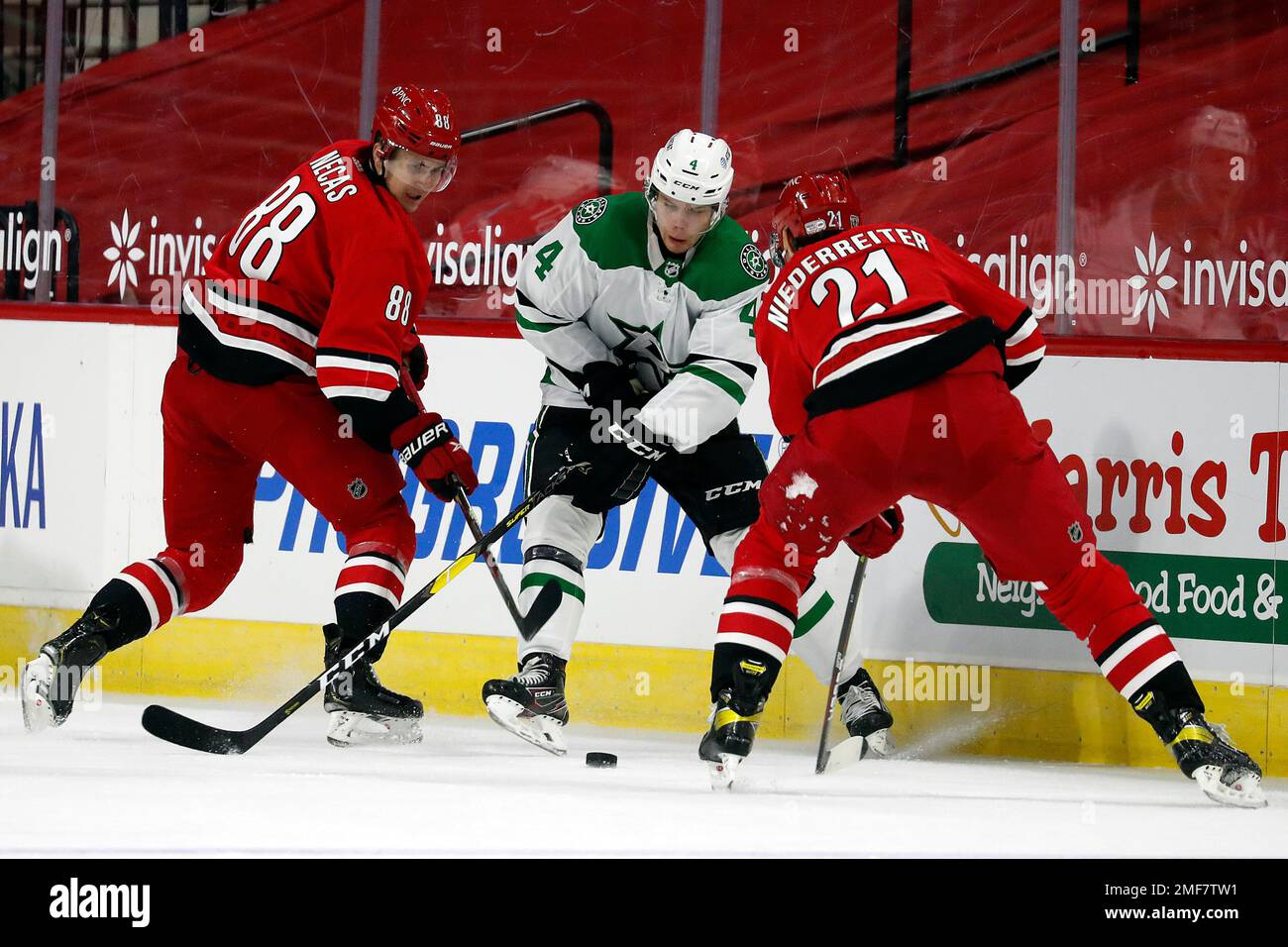 Dallas Stars' Joel Hanley (44) battles between Martin Necas (88) and