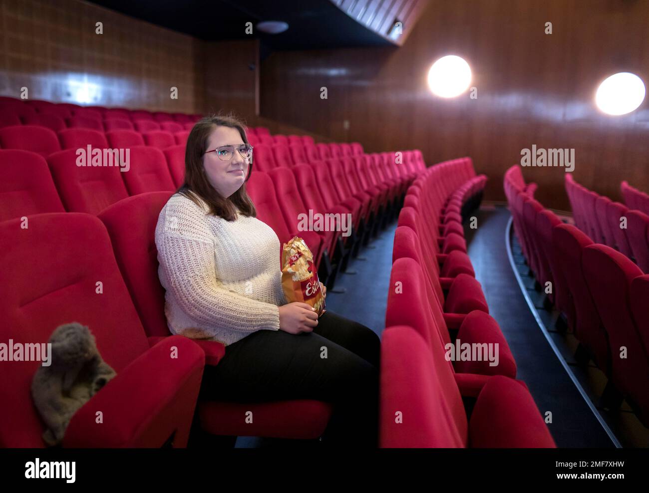 Malin Hellberg, sits alone to watch the film Tigrar, in Gothenburg, Sweden,  on Saturday, Jan. 30, 2021. The 44th Goteborg film festival opened this  weekend in a mostly virtual format. For the