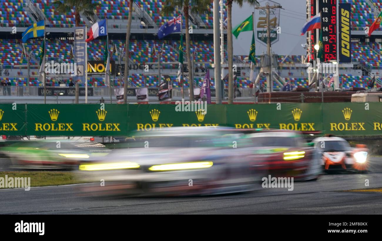 Race cars speed through the east horseshoe turn during the Rolex 24