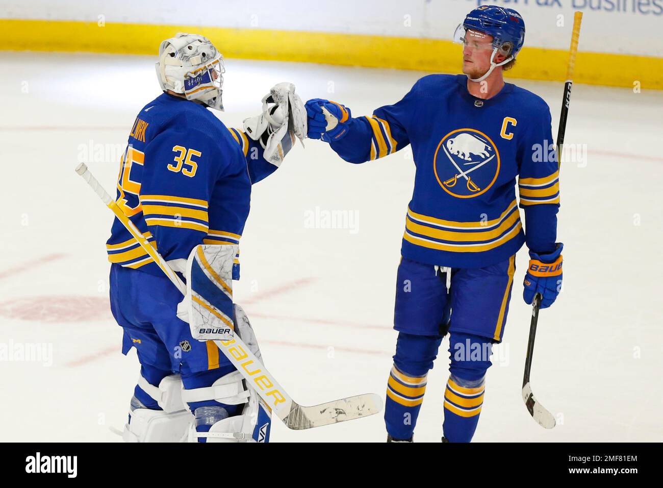 Buffalo Sabres Linus Ullmark (35) and Jack Eichel (9) celebrate a victory  following a shootout in an NHL hockey game against the New Jersey Devils,  Saturday, Jan. 30, 2021, in Buffalo, N.Y. (