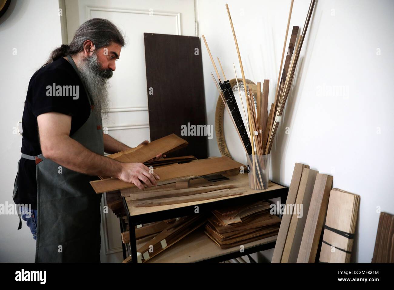 Luthier Ali Akbar Soleimani handles wood sheet to make Iranian stringed ...