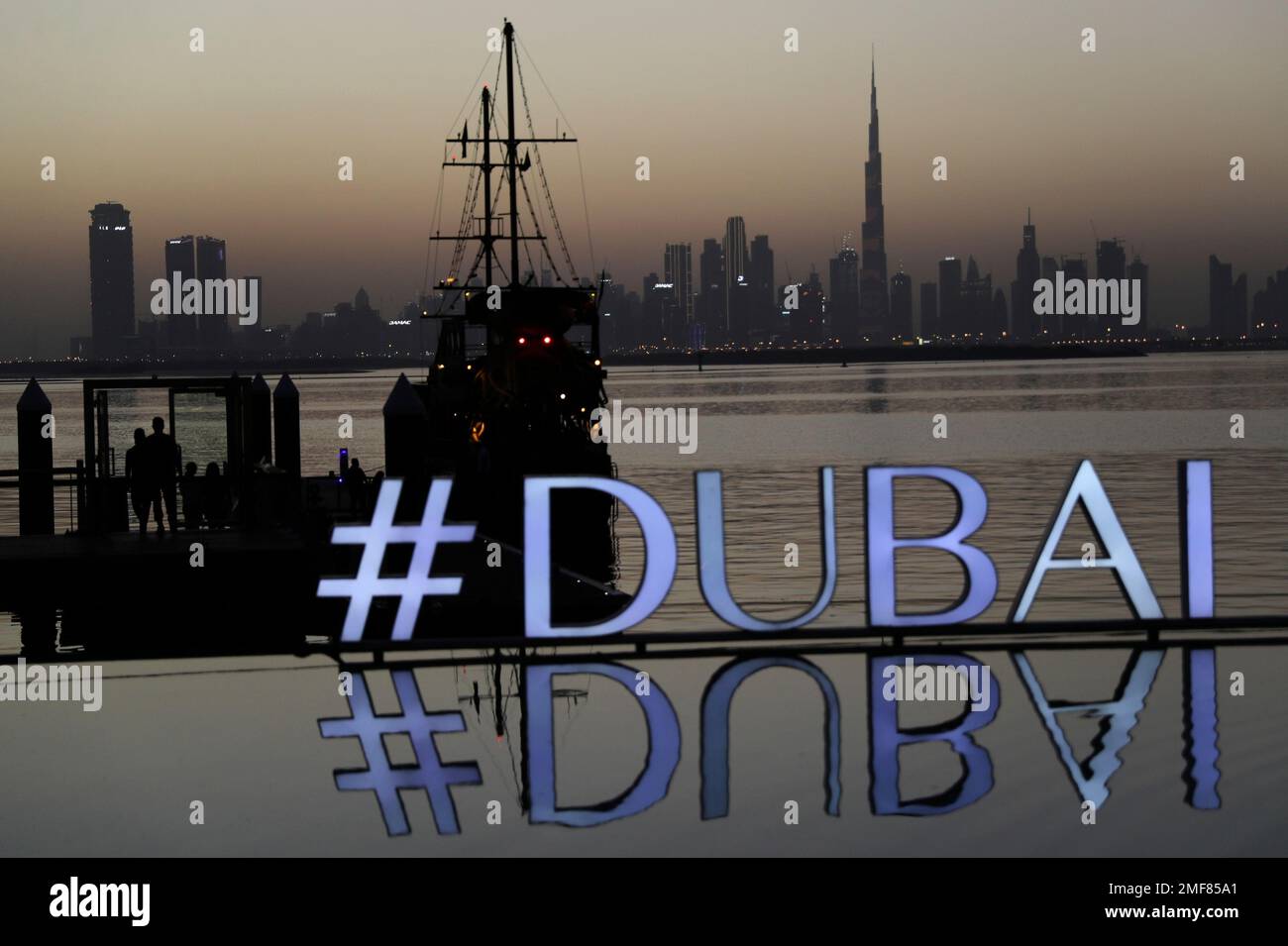 People embark a dinner dhow cruise after the sunset with the view of