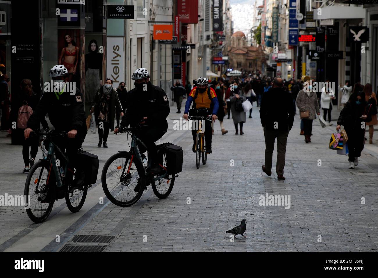 Municipal policemen patrol with bicycles on Ermou Street, Athens' main  shopping area, Friday, Jan. 29, 2021. Greece has been under lockdown-type  restrictions since early November but the hospitalizations number of new  daily